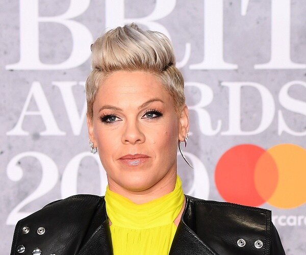 pink stands on red carpet