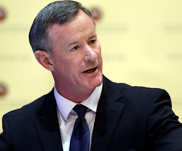 william mcraven looks to his left during a conference