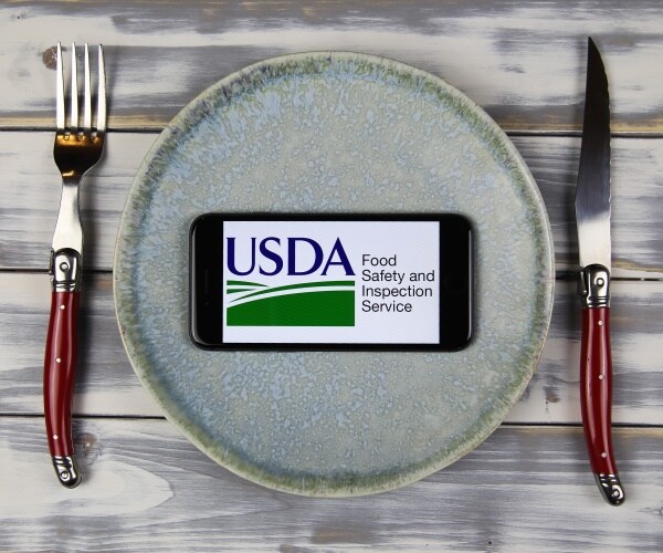 plate with USDA food safety inspection service logo on it and cutlery