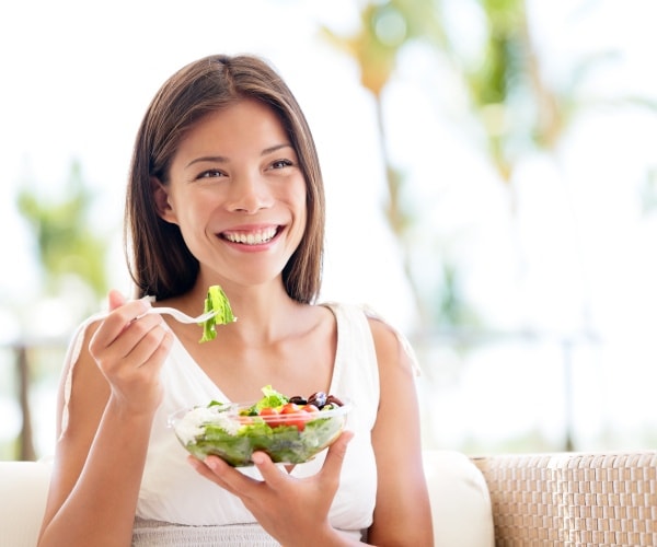 woman eating salad