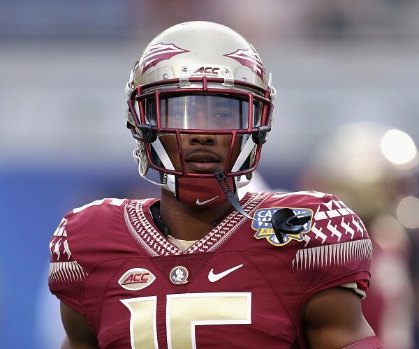 travis rudolph stands on football field