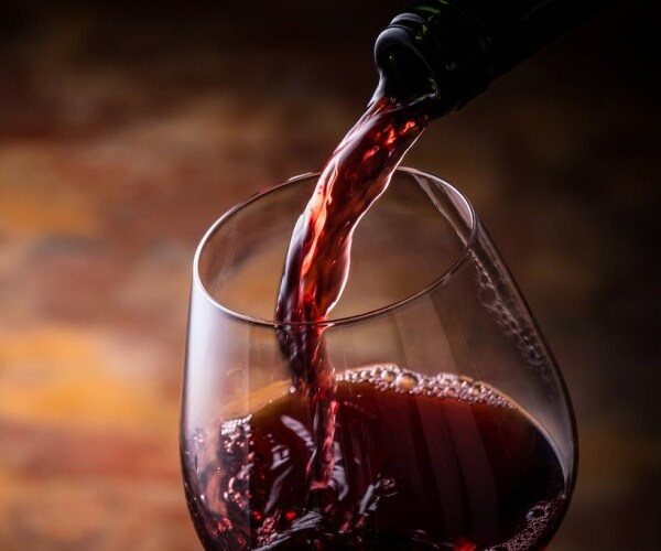 red wine being poured into a wine glass