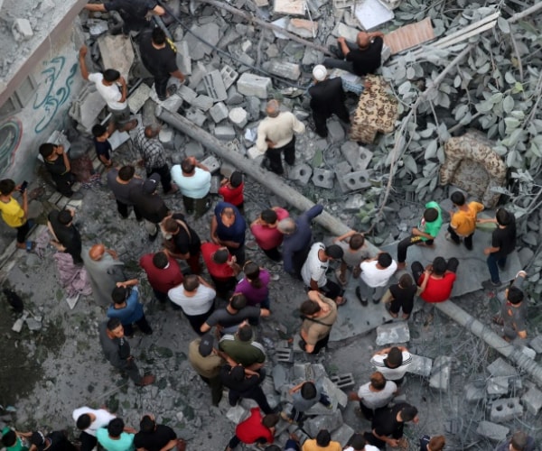 overhead view of gazans looking at rubble