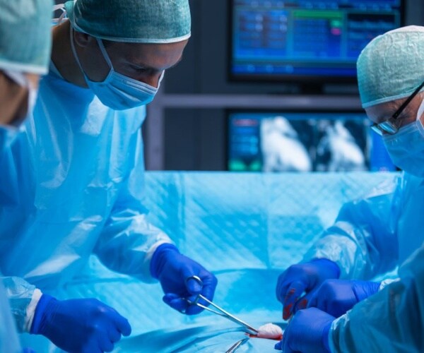 surgeons performing organ transplantation