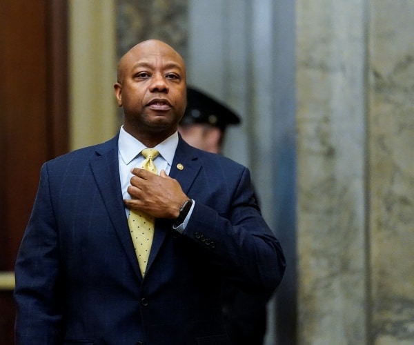 tim scott in a navy blue suit and yellow tie