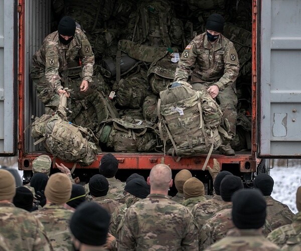 us troops retrieve their bags from truck