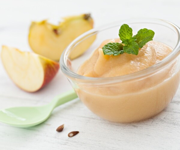 applesauce in bowl, apple slices, children's spoon