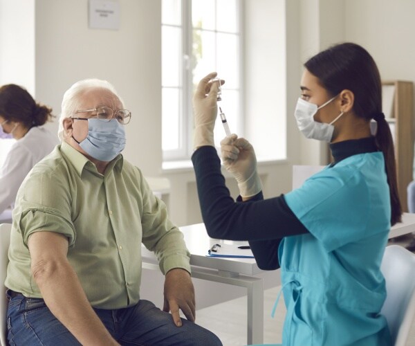 older man getting vaccine