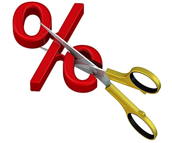 scissors cut red percentage symbol. The concept of reducing the interest rate