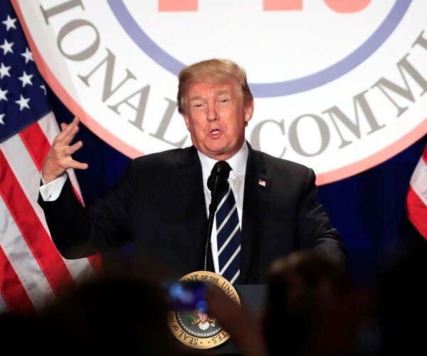 trump speaking at rnc winter meeting to a crowd