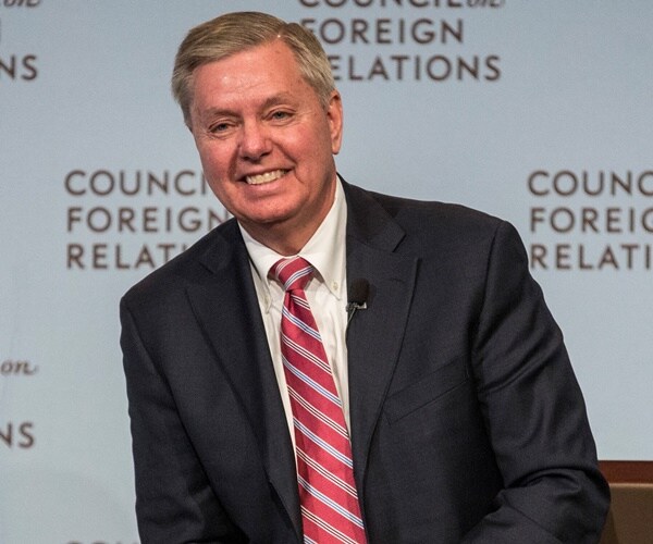 sen. lindsey graham sits on a stage at the council foreign relations.