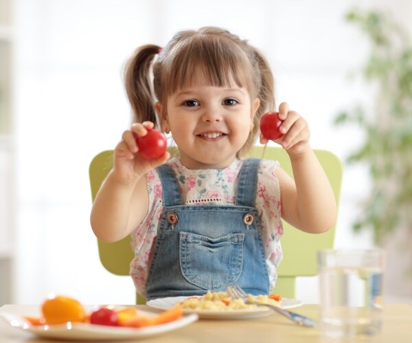 toddler eating at table