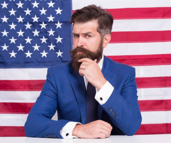 quizical man in front of american flag