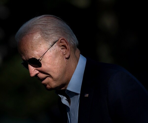 joe biden walks across lawn