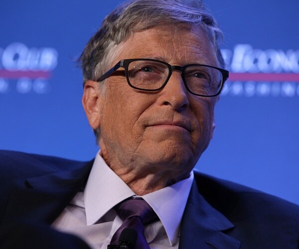 bill gates sits in chair onstage 