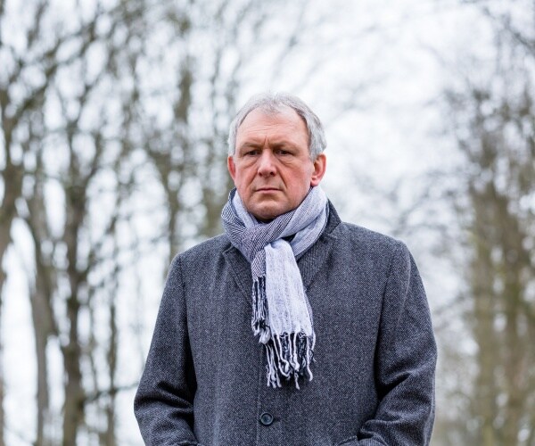 man looking sad walking outside in winter