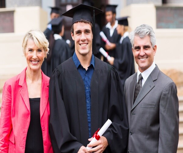 a male college graduate with his parents