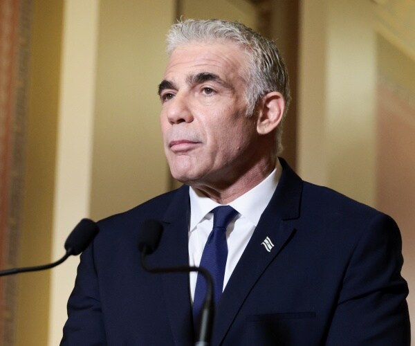 Yair Lapid speaks into a microphone