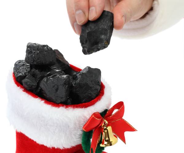 santa putting coal into a christmas stocking