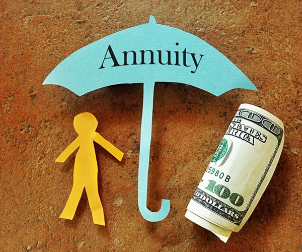 annuity umbrella over a paper cutout person and hundred dollar bill 