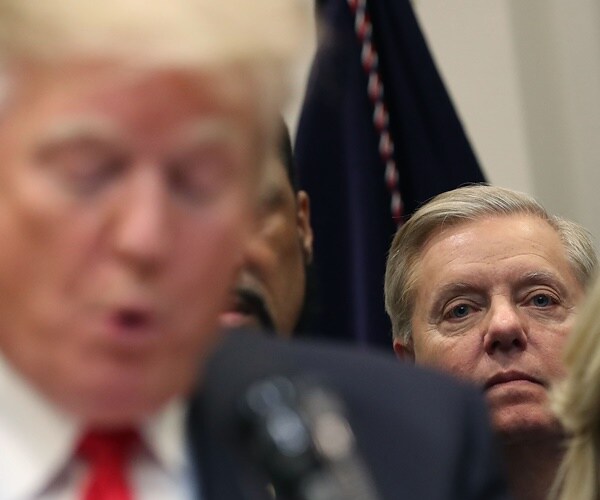 lindsey graham sits behind and listens to president donald trump