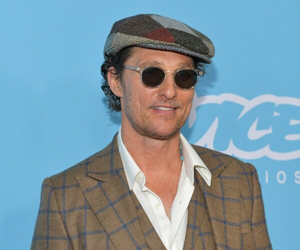 matthew mcconaughey wears sunglasses and a hat at a premier