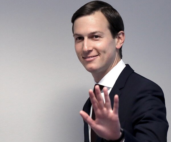 jared kushner waves to the media as he walks into a senate committee meeting