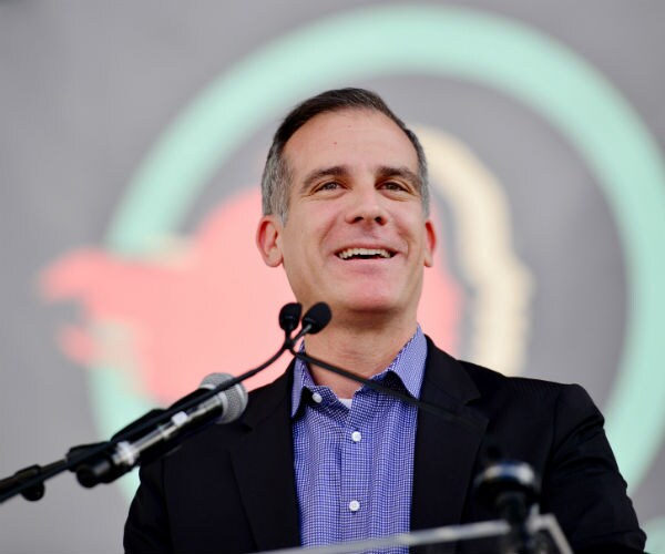 los angeles mayor eric garcetti is shown in a blue button-down shirt with a black jacket