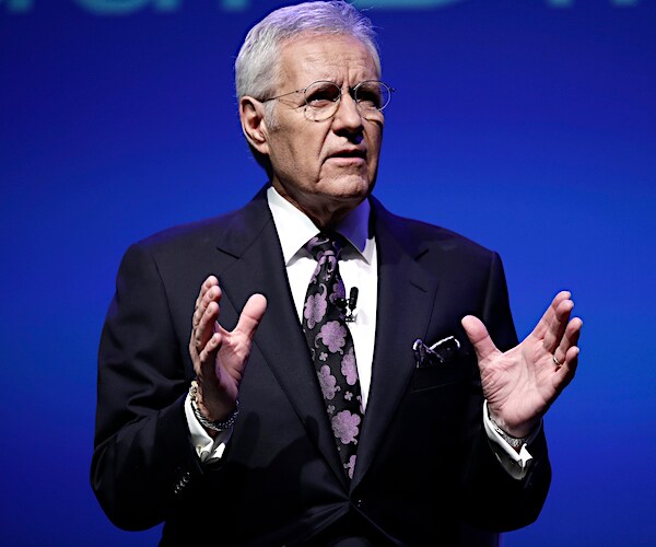 alex trebek gestures while speaking during a forum