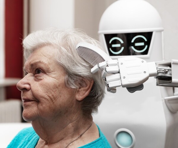 robot combing hair of older woman