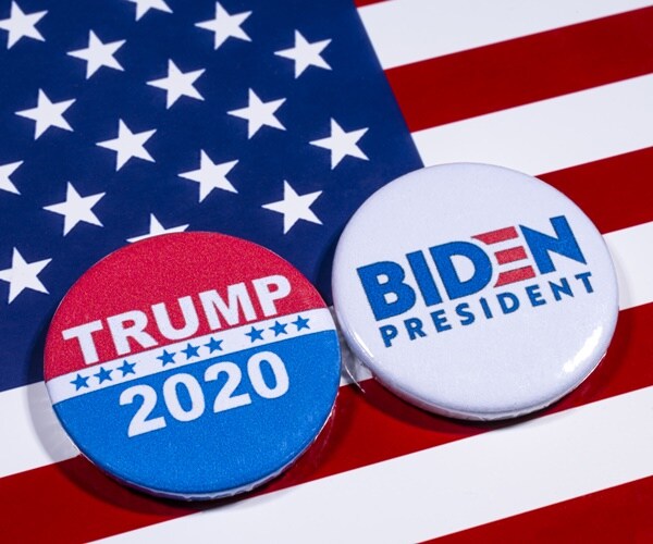 a trump button vs. a biden button