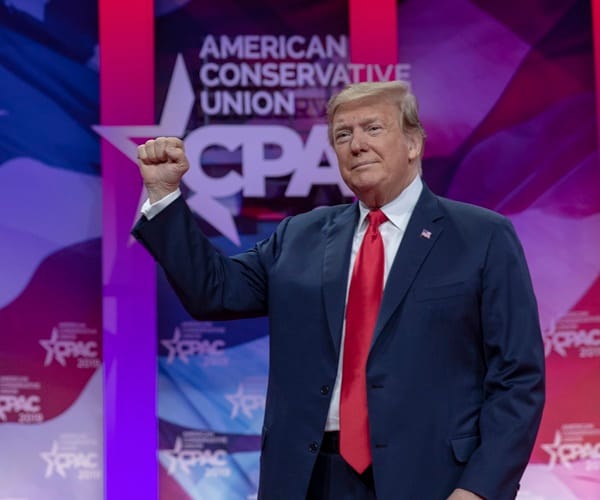 donald trump raises a fist at the 2019 cpac conference