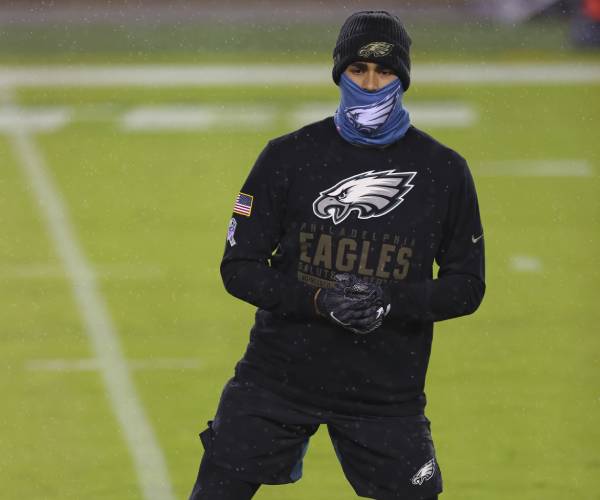 player working out with a face mask on the field