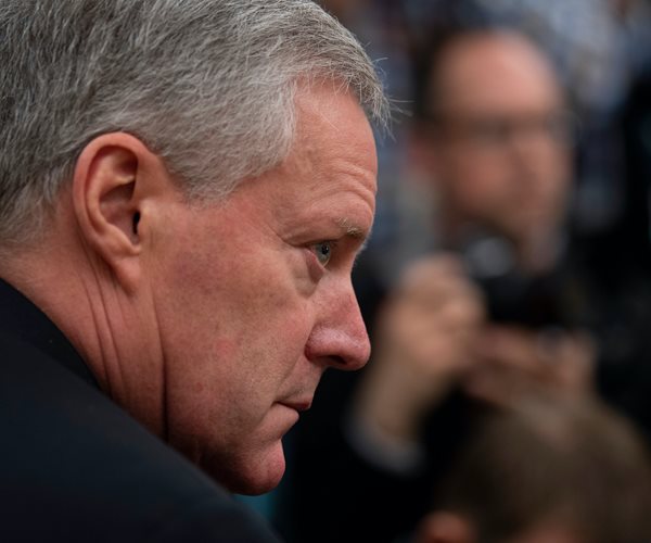 mark meadows headshot in profile facing to the right of the frame with blurred background