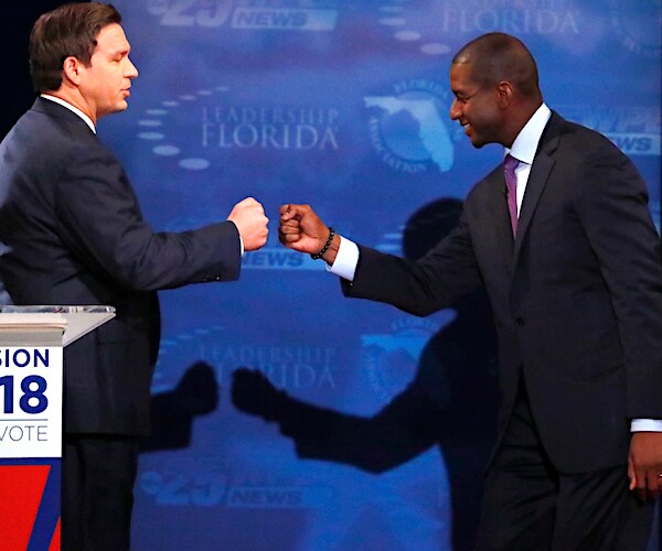 florida republican ron desantis fist bumps tallahassee mayor andrew gillum during a campaign debate