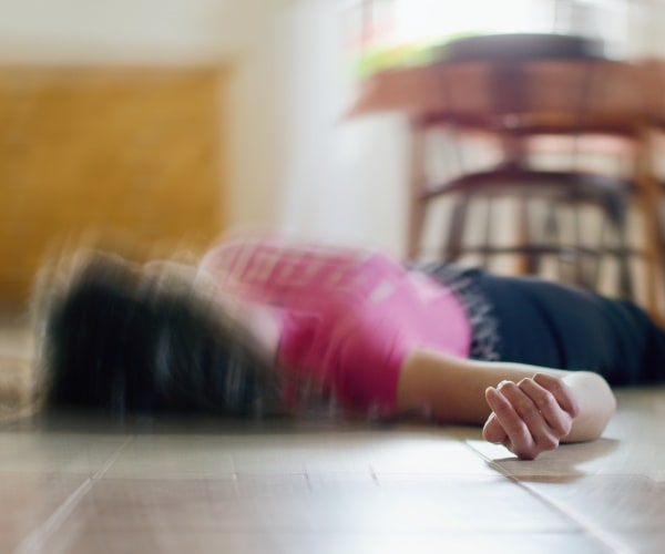 woman on floor in home after a seizure