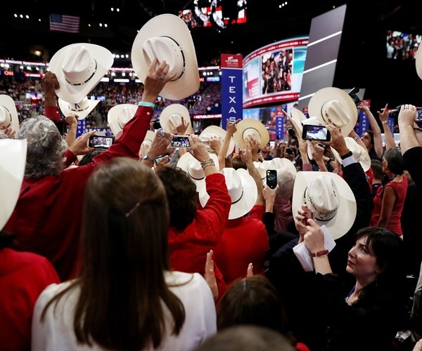 gop delegates raise their cowboy hats at the republican national convention.