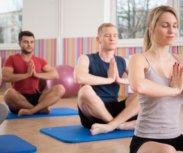 men and women in a yoga class