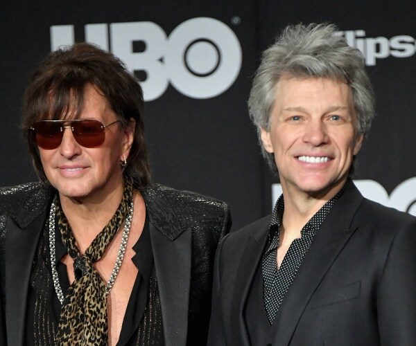 richie sambora and job bon jovie stand on red carpet