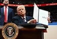 Man sitting behind the USA flag holds up a signed declaration