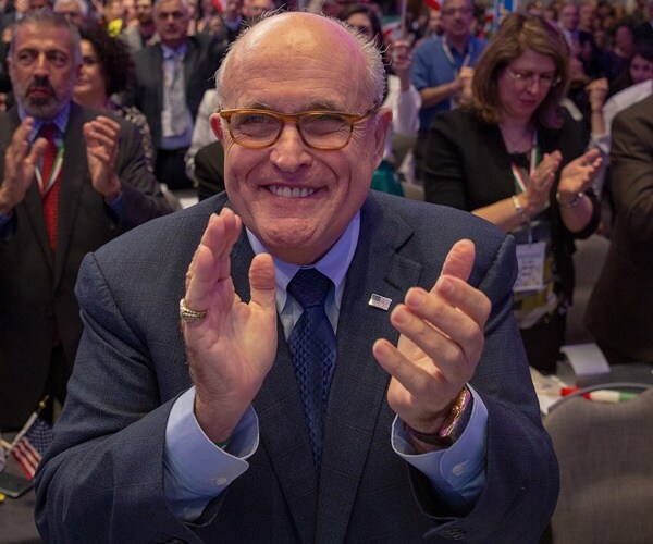 rudy giuliani is clapping at an event