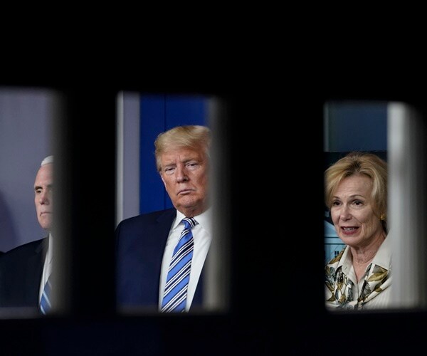 mike pence, donald trump and deborah birx are seen through windows at a press briefing