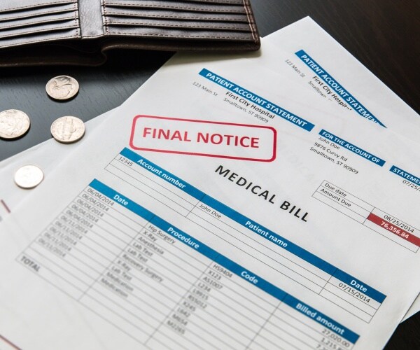 a medical bill from hospital that says "final notice", open empty wallet with change on table