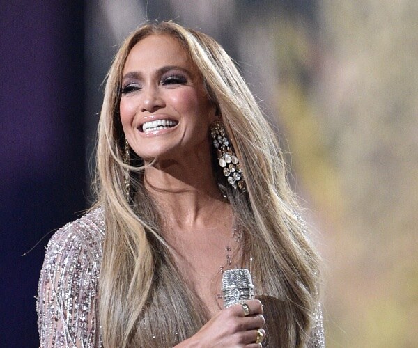 jennifer lopez smiles as she performs onstage