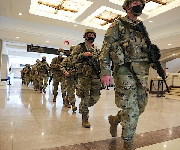 national guard troops march through the capitol building in washington, dee see