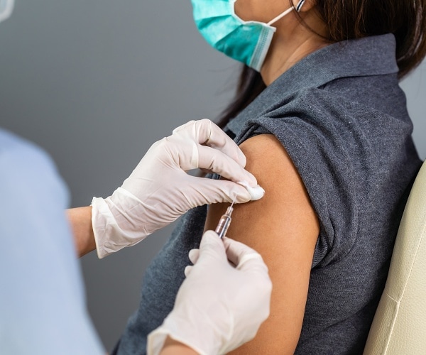 doctor giving patient shot in arm