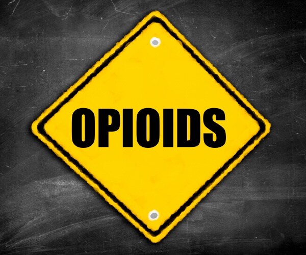 Opioid written on yellow caution road sign