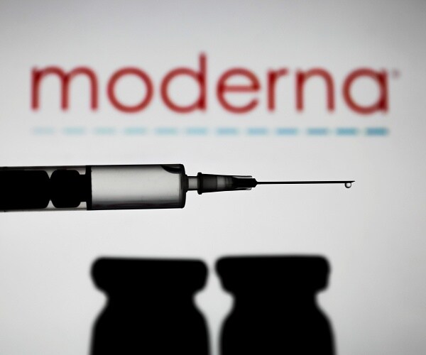 syringe in front of moderna logo