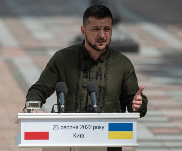 volodymyr zelenskyy speaks into a microphone