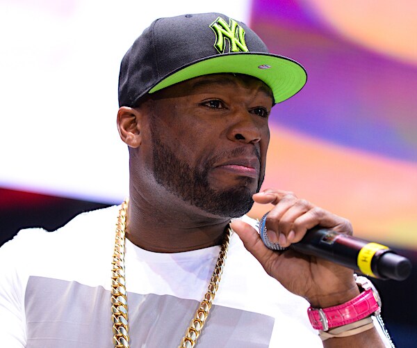 fifty cent holds the mic during a show